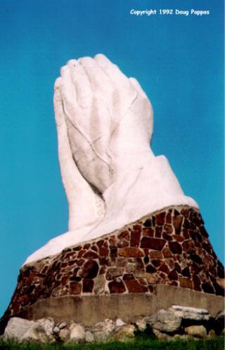 World's ugliest praying-hands statue, Webb City, MO - looks like a giant trying to escape from an underground tomb