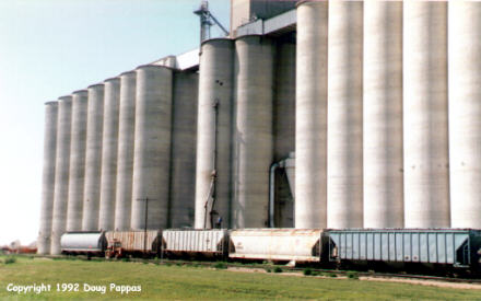 Filling rail car at grain elevator, Weskan, KS