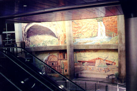 Murals with an Arizona theme, visible from escalator